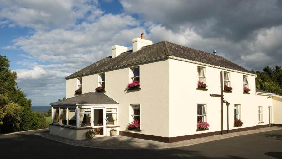 Cream house with pink window boxes