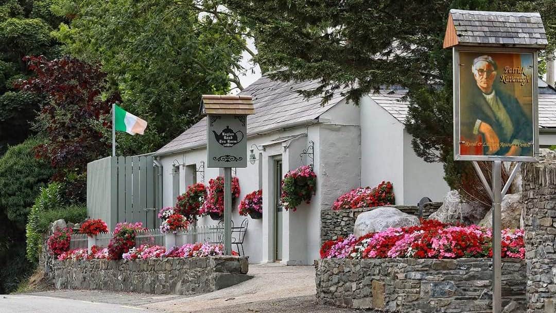 Exterior of a tearoom with stone walls and colourful flowers