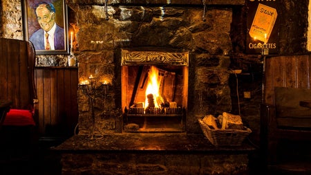 A view of the turf burning open fireplace at The Bloody Stream