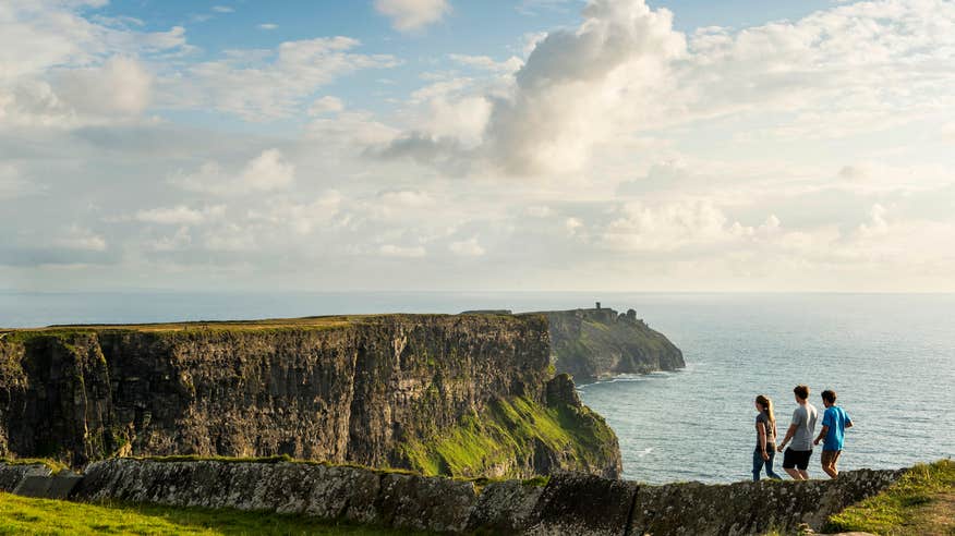People walking along the Cliffs of Moher in Co Clare