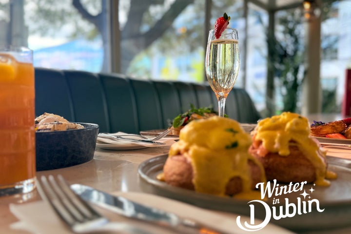 Image of brunch display with eggs royale, and a glass of prosecco