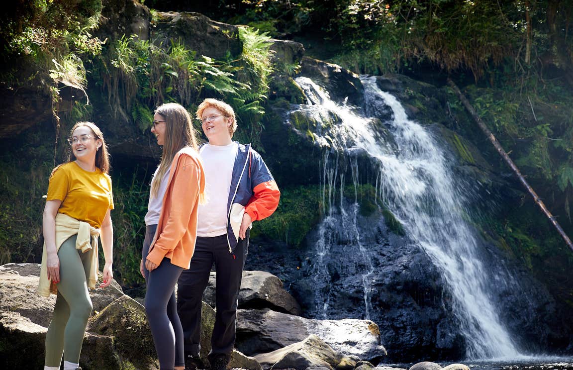 People standing by the waterfall on the Glenbarrow Eco Walk, Co Laois
