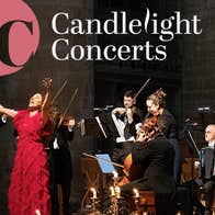 A woman in red dress with outstretched arms is singing with small group of musicians behind her