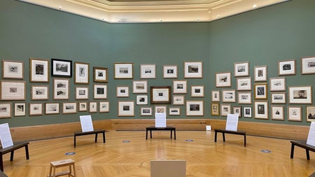 A large room with lots of framed pictures on the walls