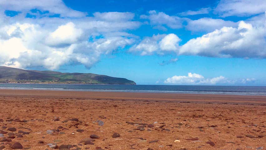 Sandy beach and blue sky with clouds