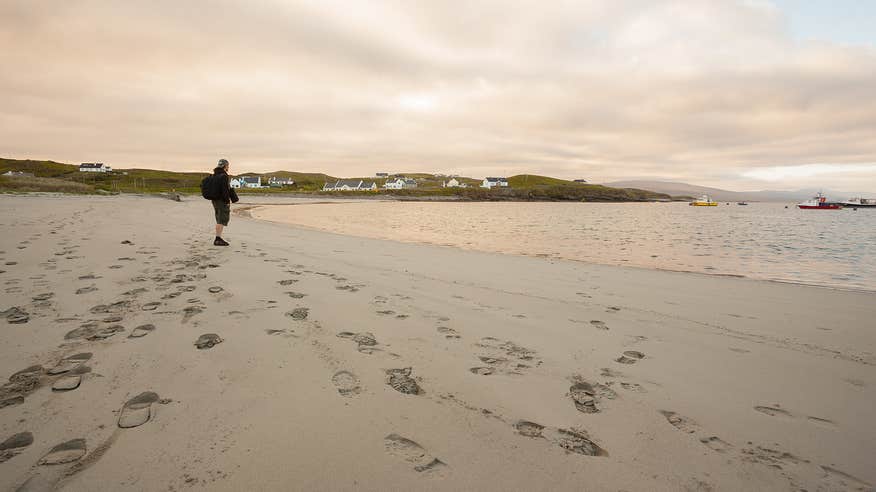 A man standing on the beach on Clare Island in County Mayo.