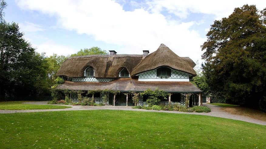 A thatched roof building with trees nearby in Cahir, Tipperary