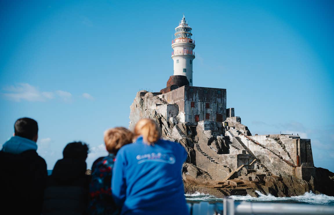People on a boat tour to Fastnet Rock Lighthouse in Co Cork