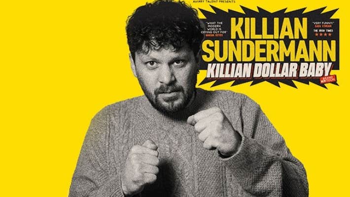 Killian Sunderland, Killian Dollar Baby - a man in knitted jumper holding his hands up in 2 fists.