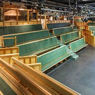 Tiered seats facing a stage in a theatre