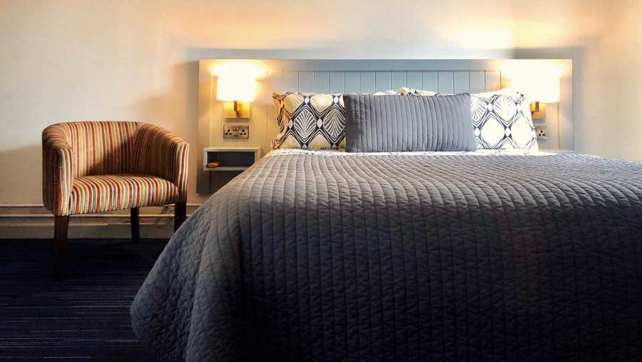 double bedroom with bedside chair