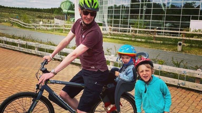 Dad and two kids off on a cycle in Centre Parcs, Longford