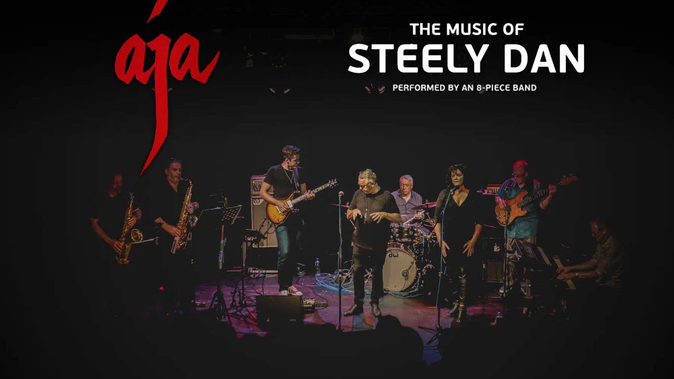 A group of 8 musicians on a small stage