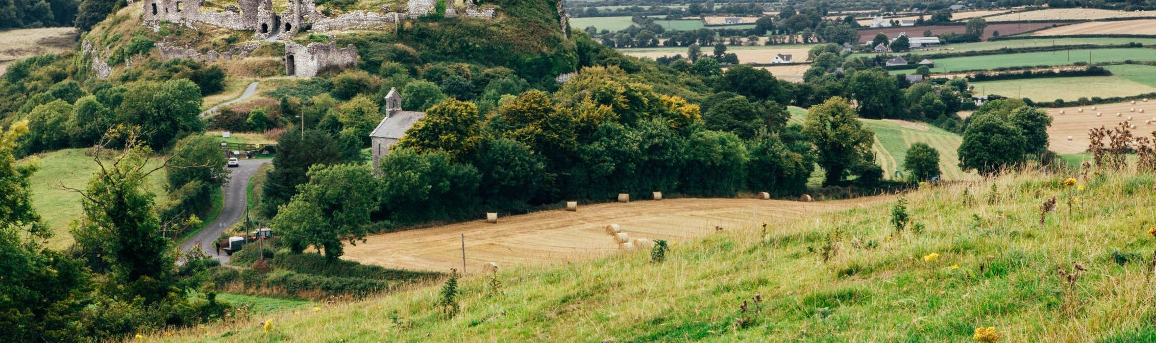 Rolling green hills in front of the Rock of Dunamase in County Laois