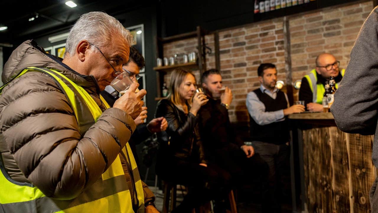 People in a tasting room sampling beer