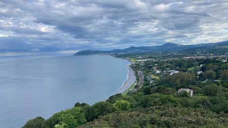 Aerial view of a coastline with mountains in the background