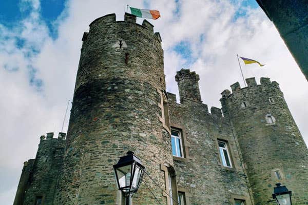 Enniscorthy Castle with two turrets and a flag flying from the top of each one