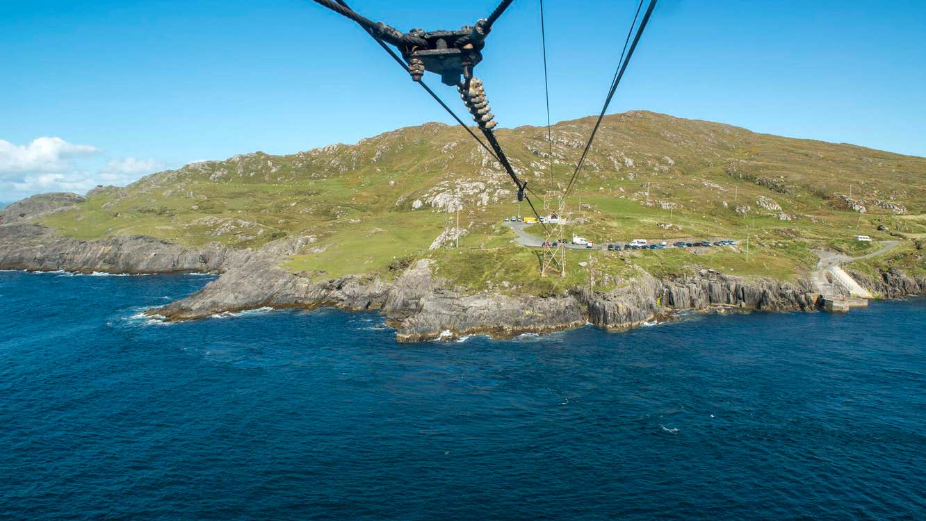 Cables above the sea with mainland in the background
