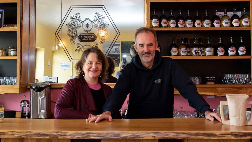 Two people standing behind a counter in Kinsale Mead Company