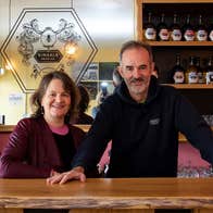 Two people standing behind a counter in Kinsale Mead Company