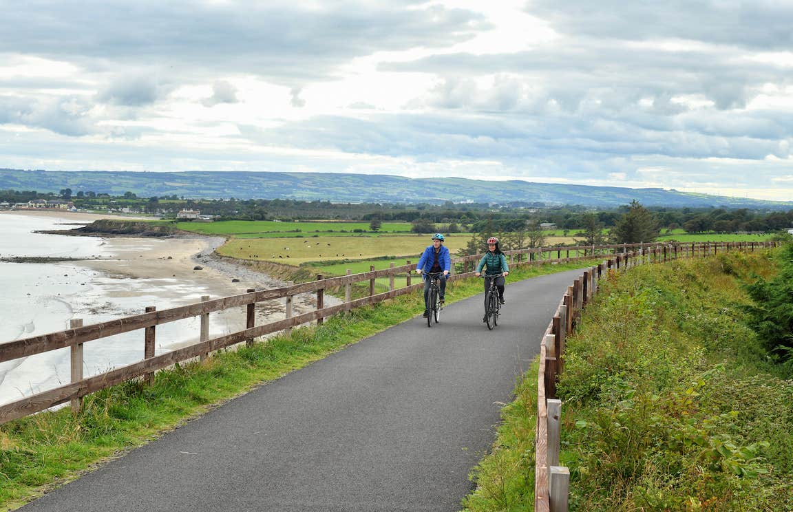 Two people cycling the Waterford Greenway.