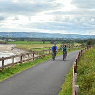 Two people cycling the Waterford Greenway.