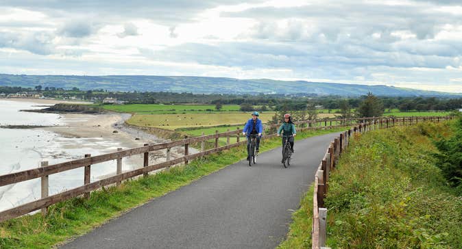 Two people cycling the Waterford Greenway.