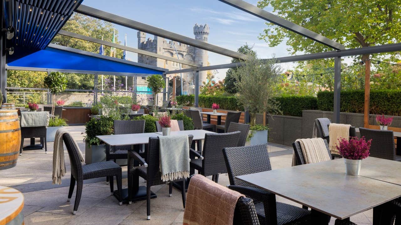 Outdoor terrace with stylish seating and castle views