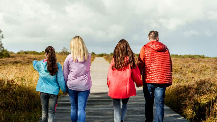 Family walking along the track way at Corlea Bog