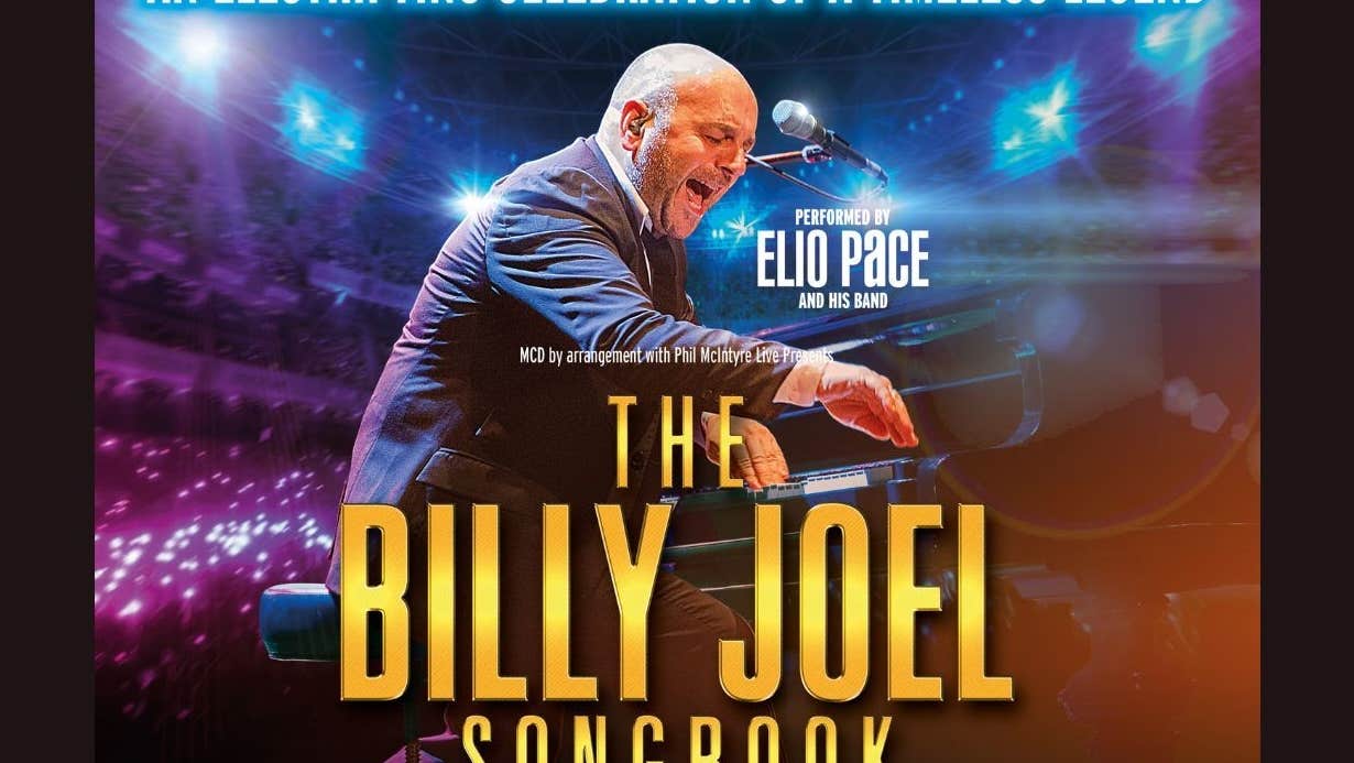 An lively man singing and playing a piano