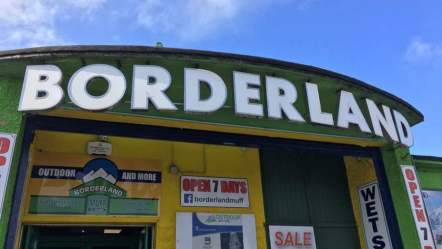 Green and yellow exterior signage and entrance to Borderland Muff