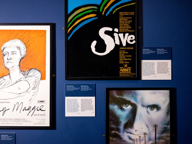 3 different posters displayed on a wall with small info details.