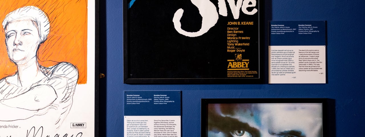 3 different posters displayed on a wall with small info details.