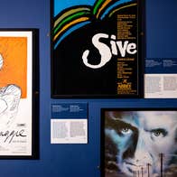 3 different posters displayed on a wall with small info details.