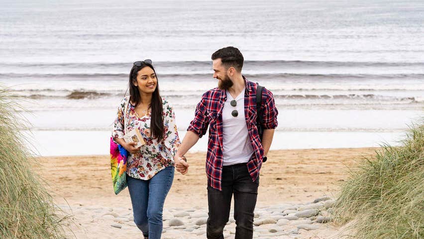 Couple walking on the beach at Doonbeg, County Clare