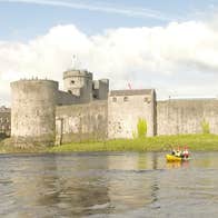 A view of King Johns Castle from the water on a kayaking tour with Nevsail Watersports