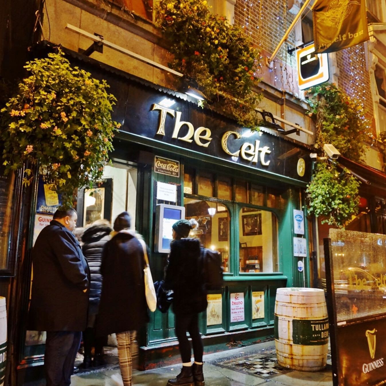 Group of people walking into The Celt bar in Dublin.
