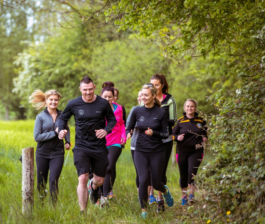 A group running in nature during a retreat