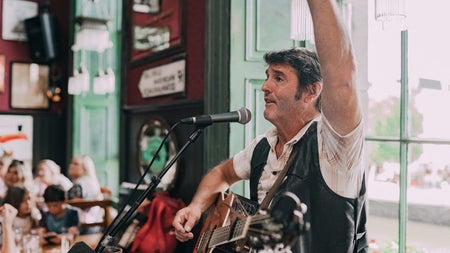 Irish musician singing and playing the guitar at The Irish Dance Party