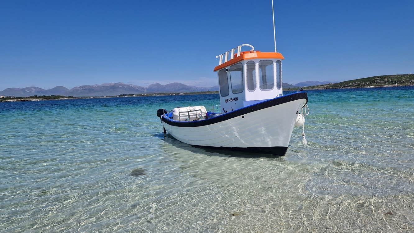 The Roundstone Bay & Island Boat Benbaun moored in the waters off Inishlacken Island
