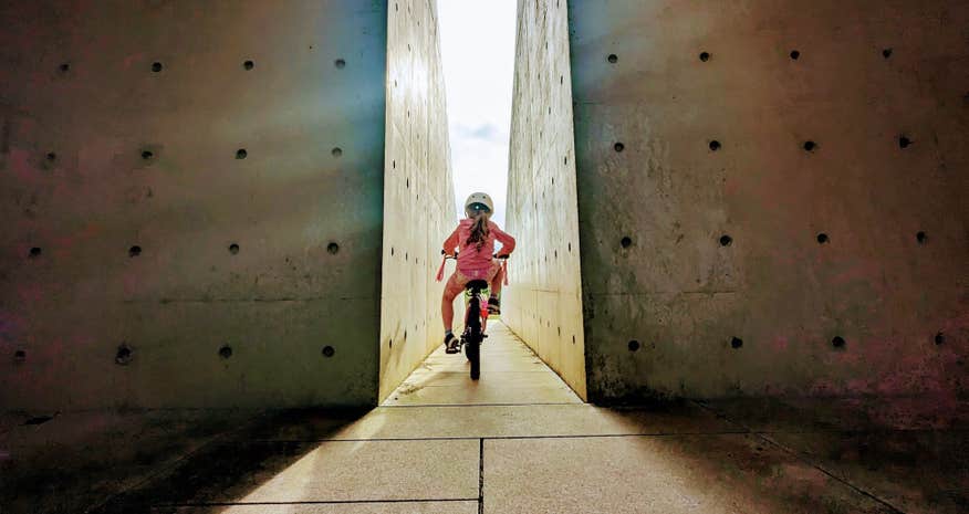 A little girl cycling through the Oulart Hill monument in County Wexford.
