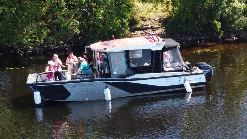 Passengers on a small boat enjoying a tour on a lake