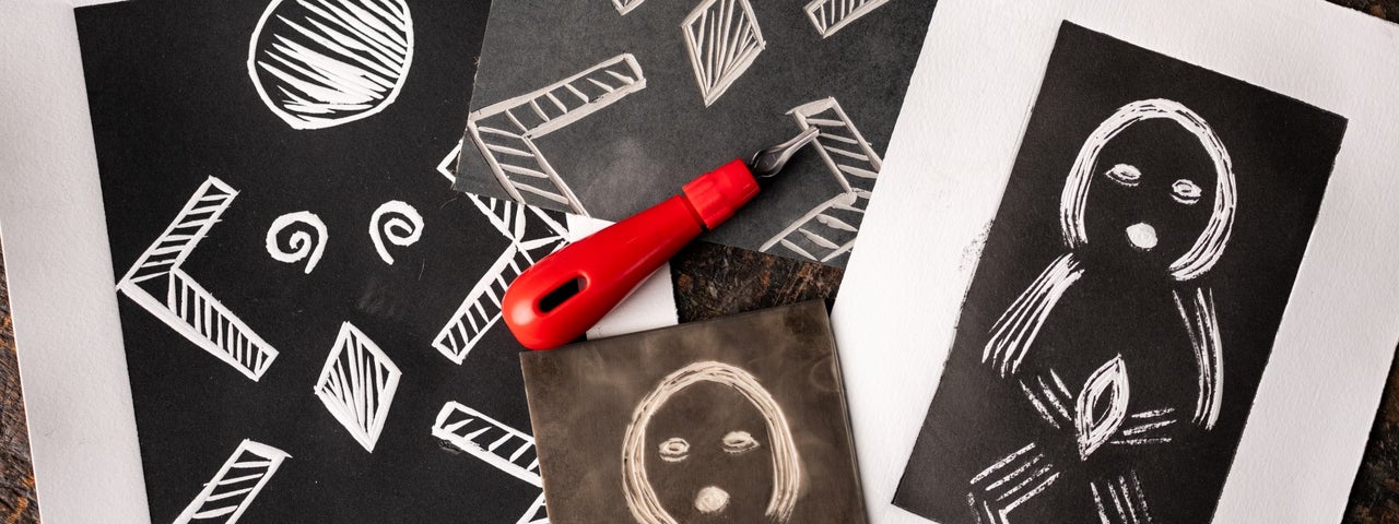 Looking down at art works in black and white on a table