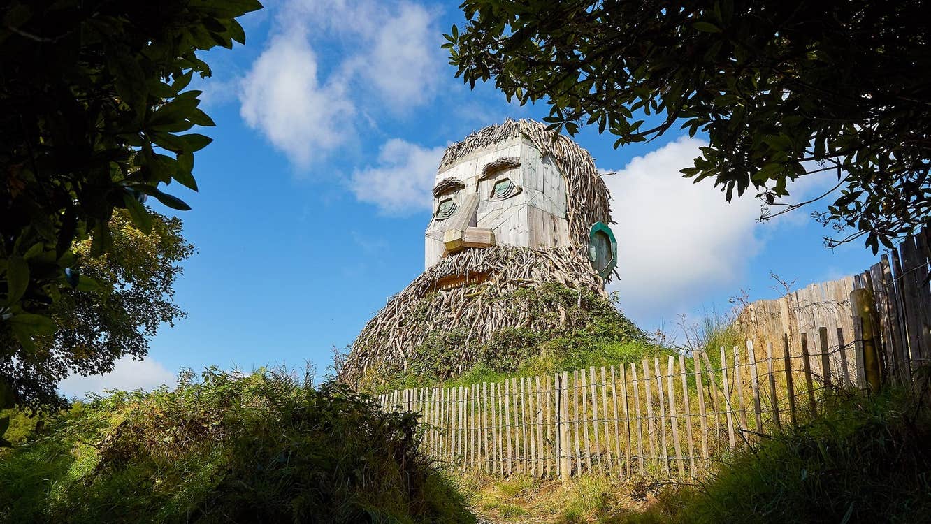 Wooden sculpture of giant man with a beard in a park