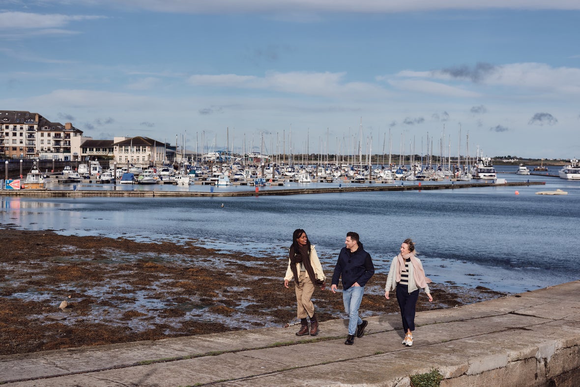 People walking along Malahide Marina