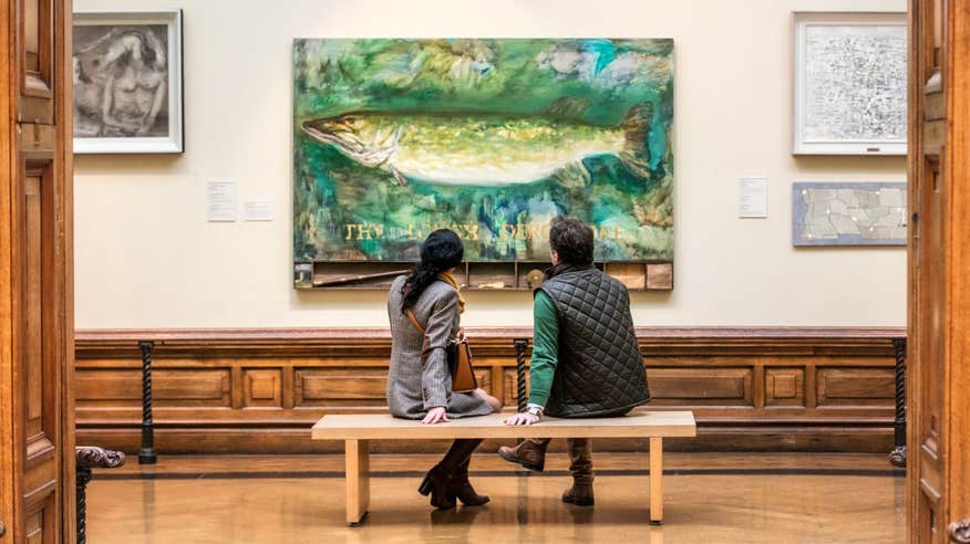 Two people looking at a painting in Crawford Art Gallery, Cork