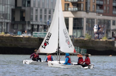 Two dinghies on a river in a city