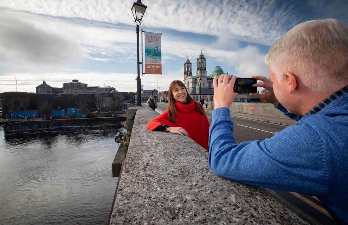 A man taking a picture of a woman in Athlone, County Westmeath.