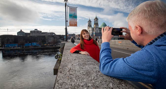 A man taking a picture of a woman in Athlone, County Westmeath.