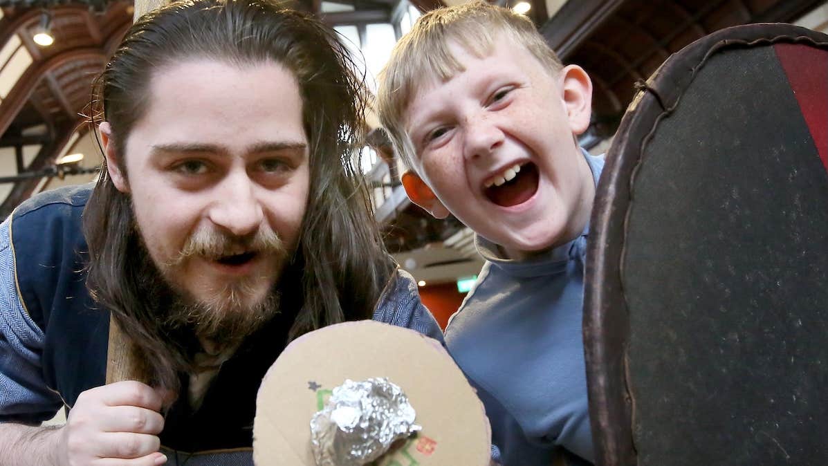 Viking and laughing boy holding shields